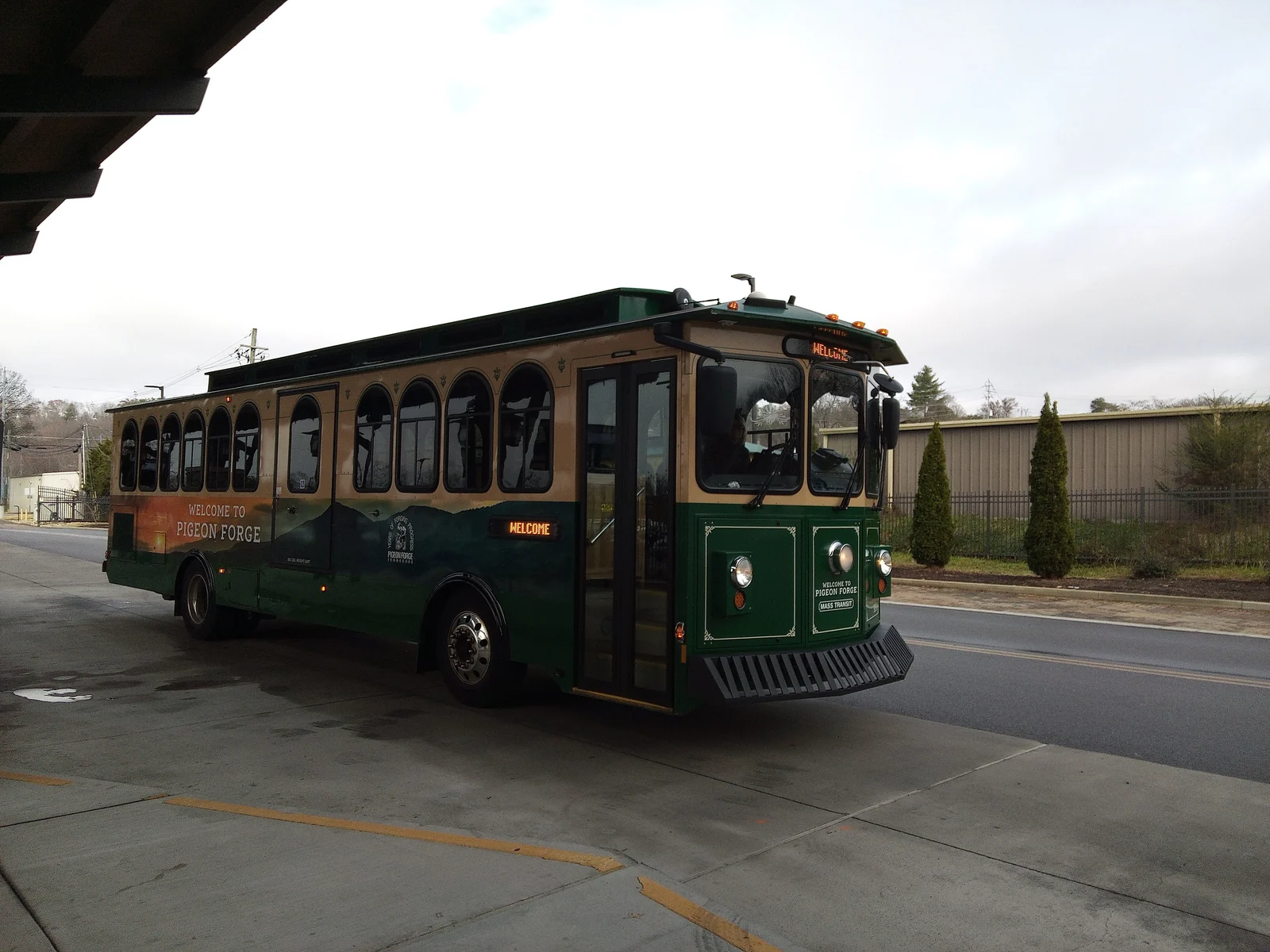 A green and cream Pigeon Forge trolley-style bus at the Mass Transit Center